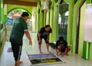 Papan edukasi pemilahan sampah organik dipasang di area teba sebagai media pembelajaran bagi keluarga dalam mengelola sampah sejak dari rumah.
